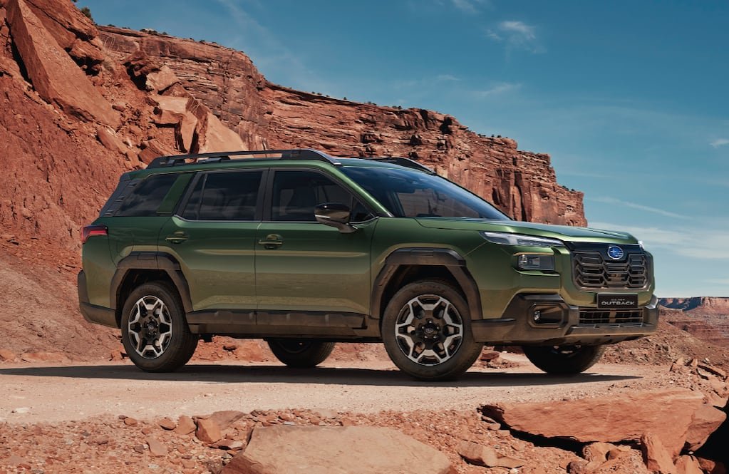 Imagen ilustrativa del nuevo Subaru Outback, un SUV verde fotografiado frente a formaciones rocosas.
