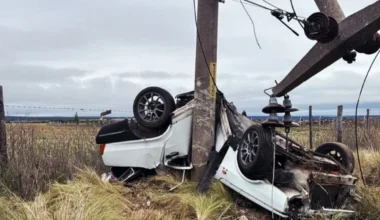 Auto volcado junto a una columna eléctrica dañada tras el accidente cerca de La Toma.