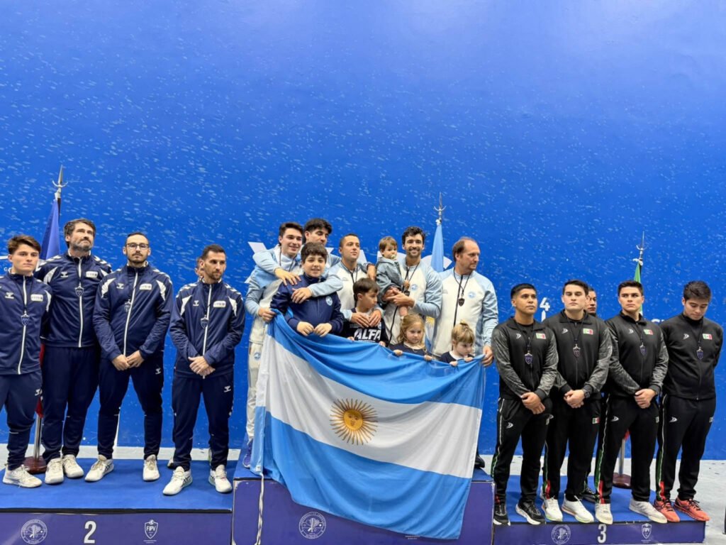La delegación argentina posa con su bandera en el podio del Mundial de Pelota Vasca de Buenos Aires.